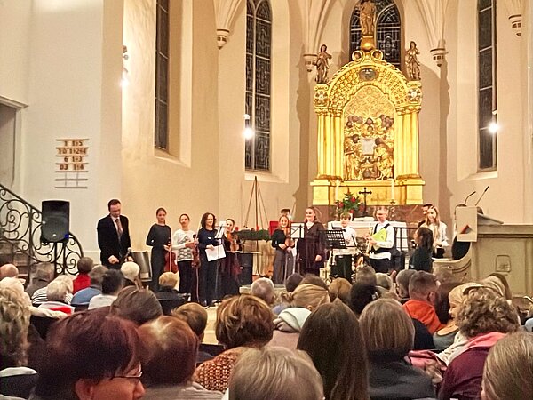Im Altarraum der Klosterkirche Riesa steht ein Ensemble. Davor sieht man das sitzende Publikum.